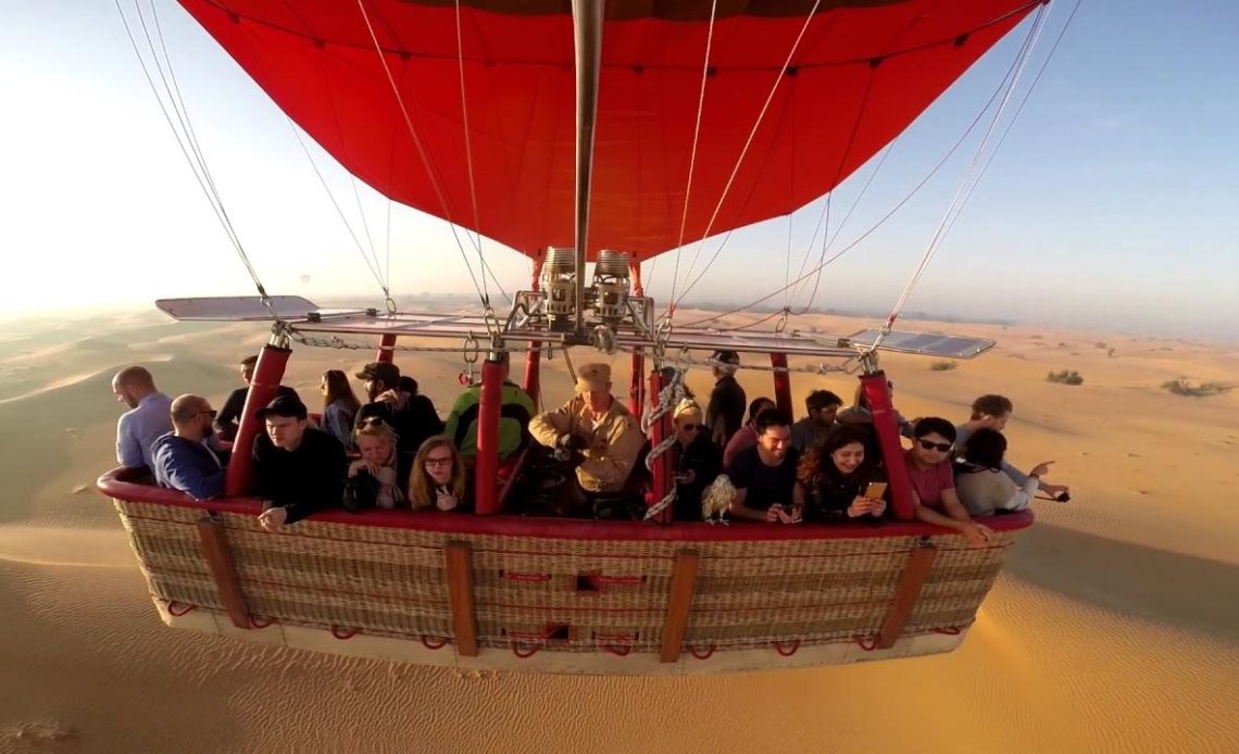 hot air ballooning at sunrise over the dubai desert